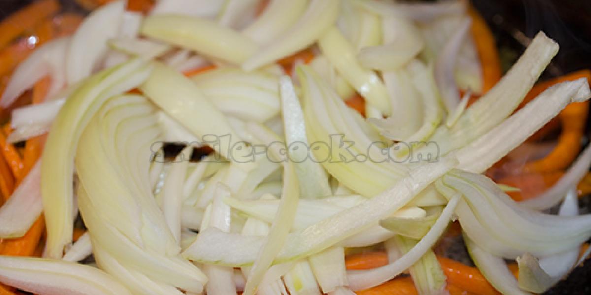 onions and carrots in a pan